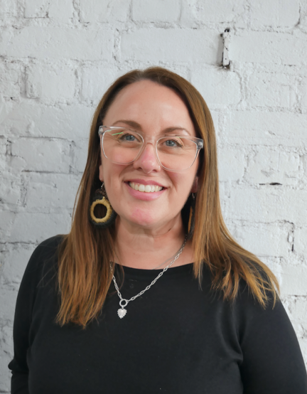 Headshot of Anita Harnden, smiling, against a white wall.
